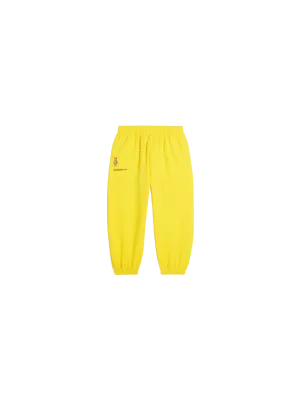 Pangaia x Haroshi BE@RBRICK™ Kids Track Pants—saffron yellow